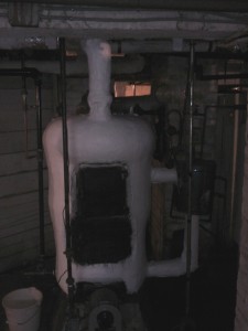 This "snowman" unit hides in the dark confines of the basement and chews up energy. The attached hot water pre-heat tank made sense in the days of coal but wastes more heat now. The steam piping is insulated with asbestos (well encapsulated here - but often in poor condition). Replacement cost: $5000 for the asbestos removal, $5000 for the boiler replacement. According to the HVAC contractor no system exists that will qualify for government subsidies. The replacement cost wipes out more than a year of rental income.